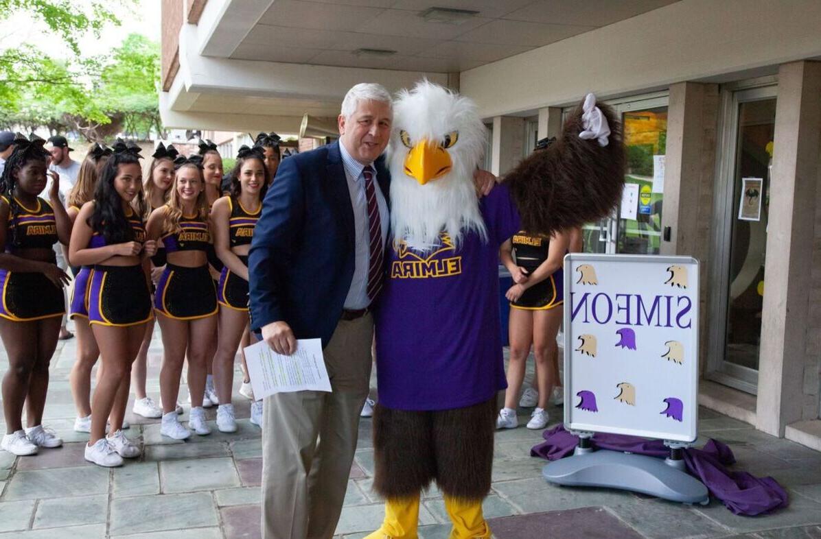 Elmira College President Charles Lindsay is pictured with mascot Simeon the Soaring Eagle